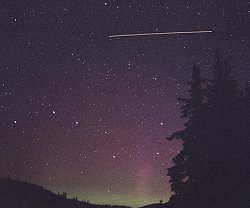 Le Québécois Dominique Cantin se trouvait dehors le 20 juillet 2002 pour photographier des aurores polaires quand l’ISS apparut. La traînée montre la distance parcourue en 30 secondes, durée de la prise de vue.